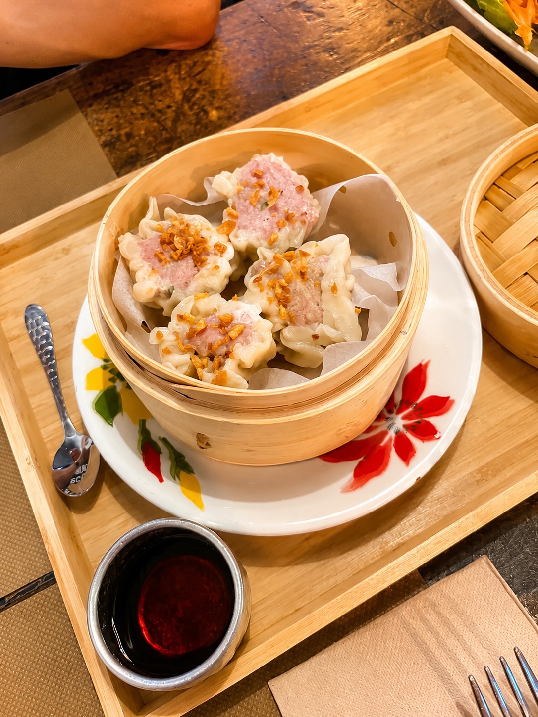 Steamed dumplings served in a bamboo basket at THAI ISAAN